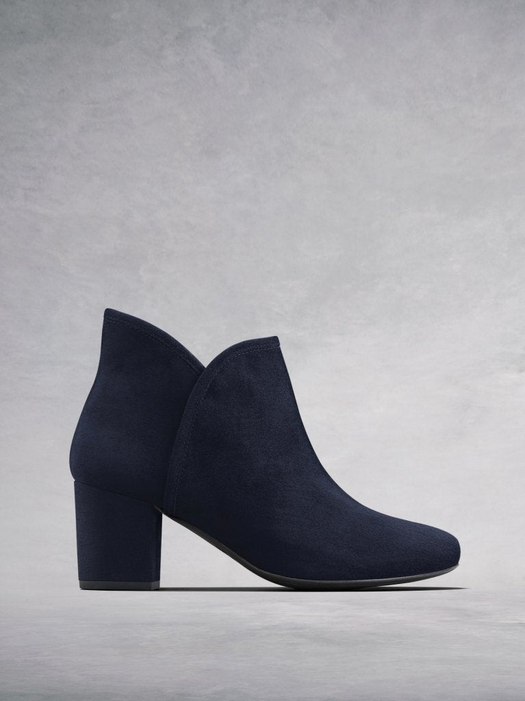 The Tigerlily, a versatile navy suede ankle boot with a sweetheart topline.