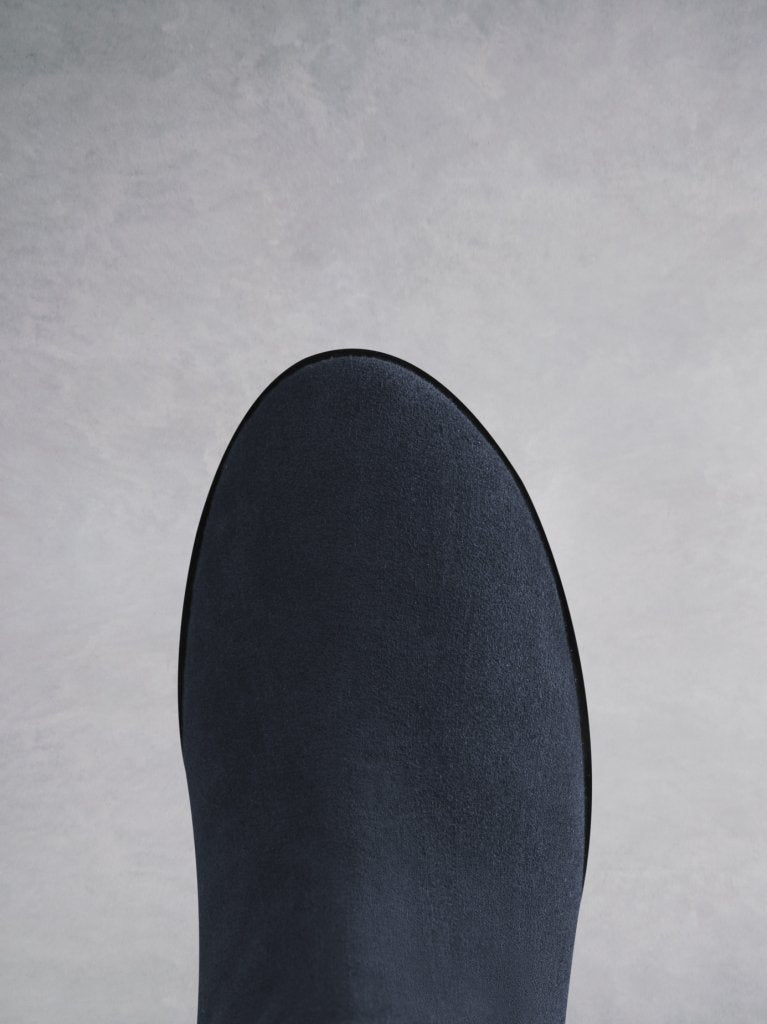 Featuring a practical round toe in navy suede on an E.V.A sole.
