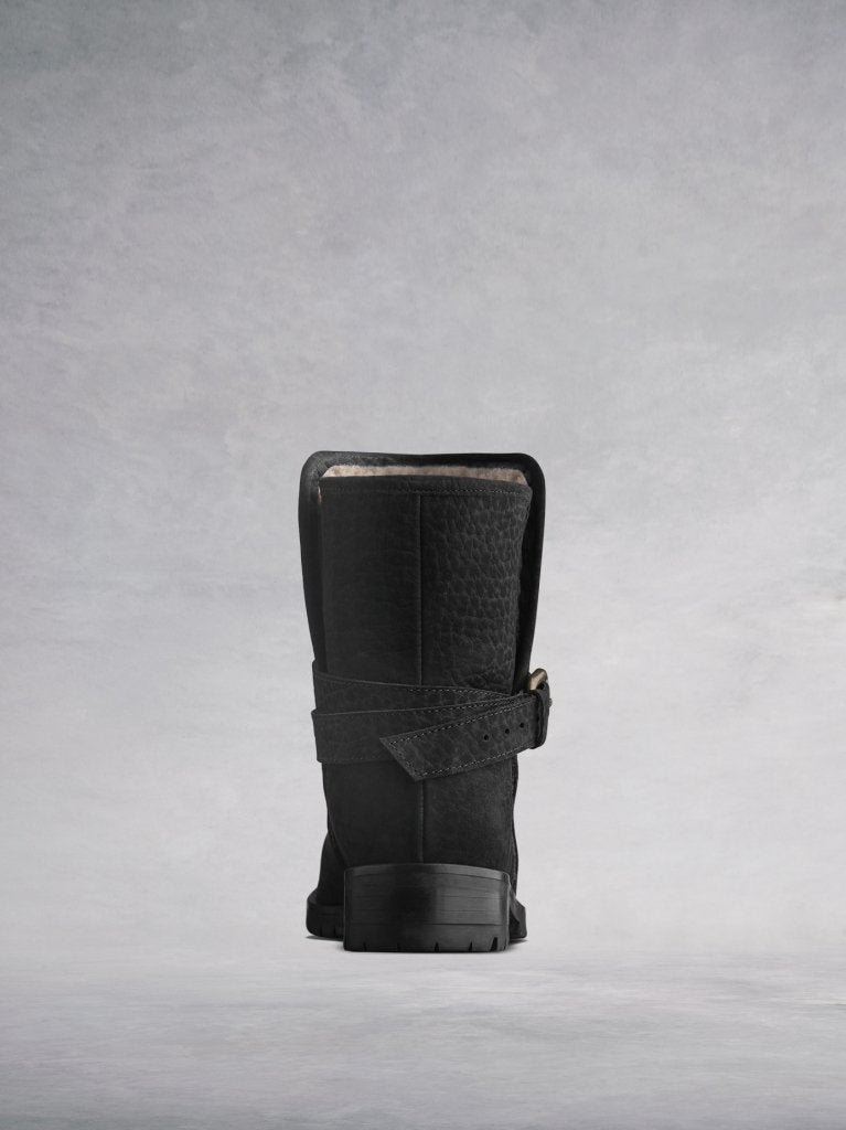 The black boot features a cross over ankle strap at the back. 