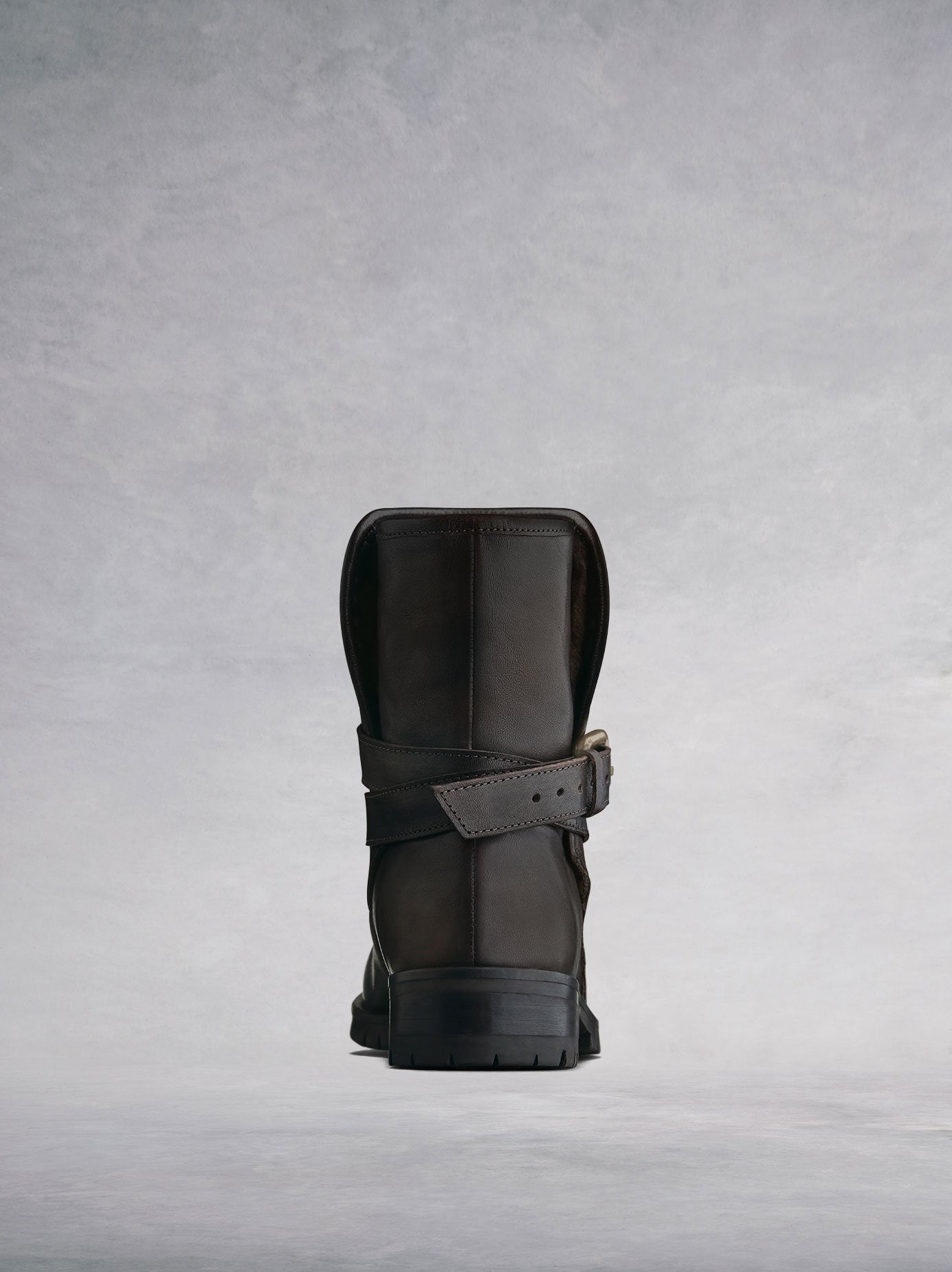 The brown boot features a cross over ankle strap at the back. 