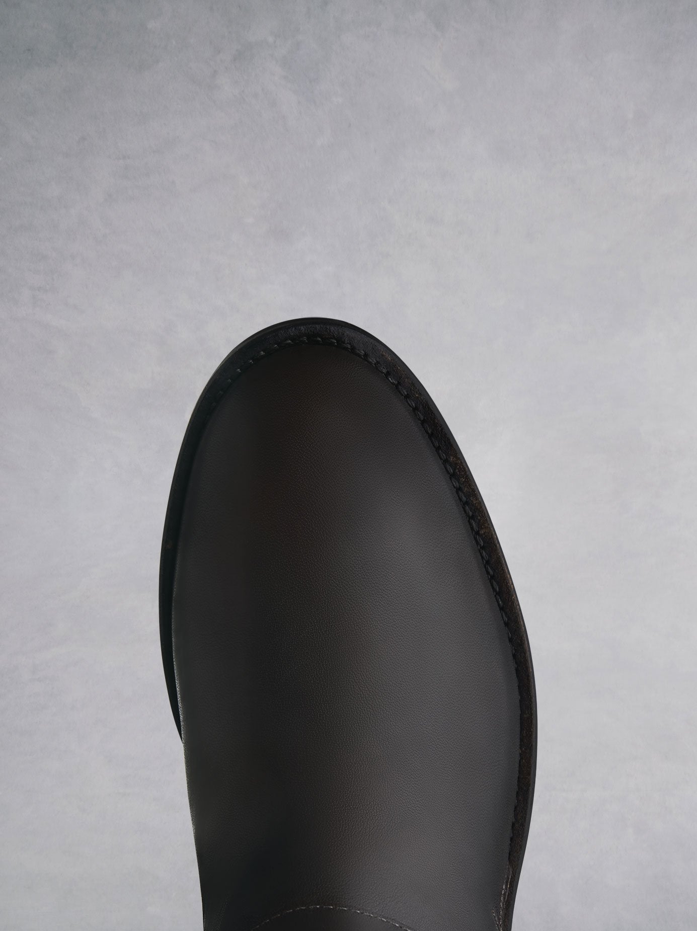 The brown ankle boot has a comfortable round toe with shearling lining. 