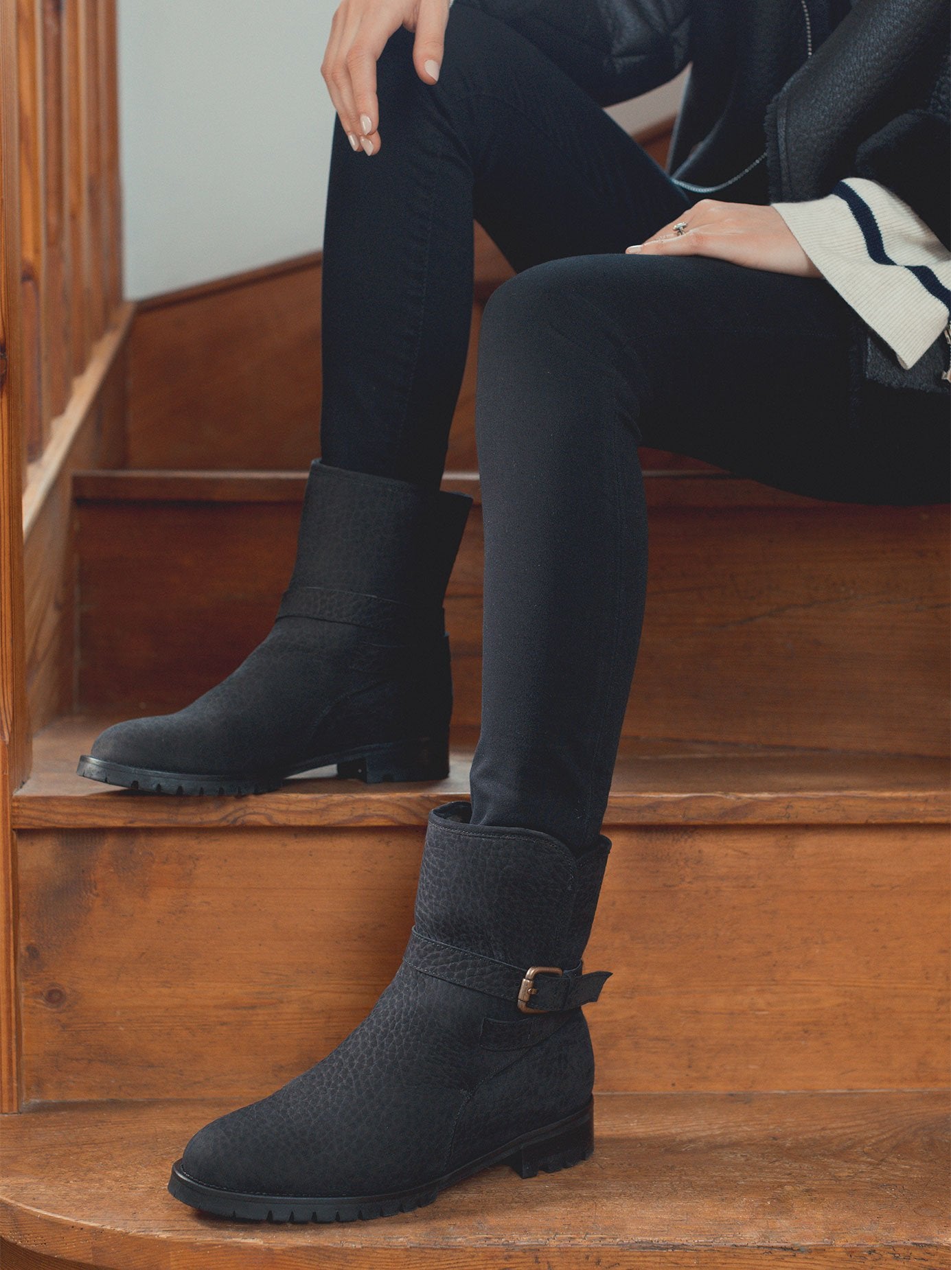 Featuring an adjustable buckled strap and a heavy tread rubber sole. 