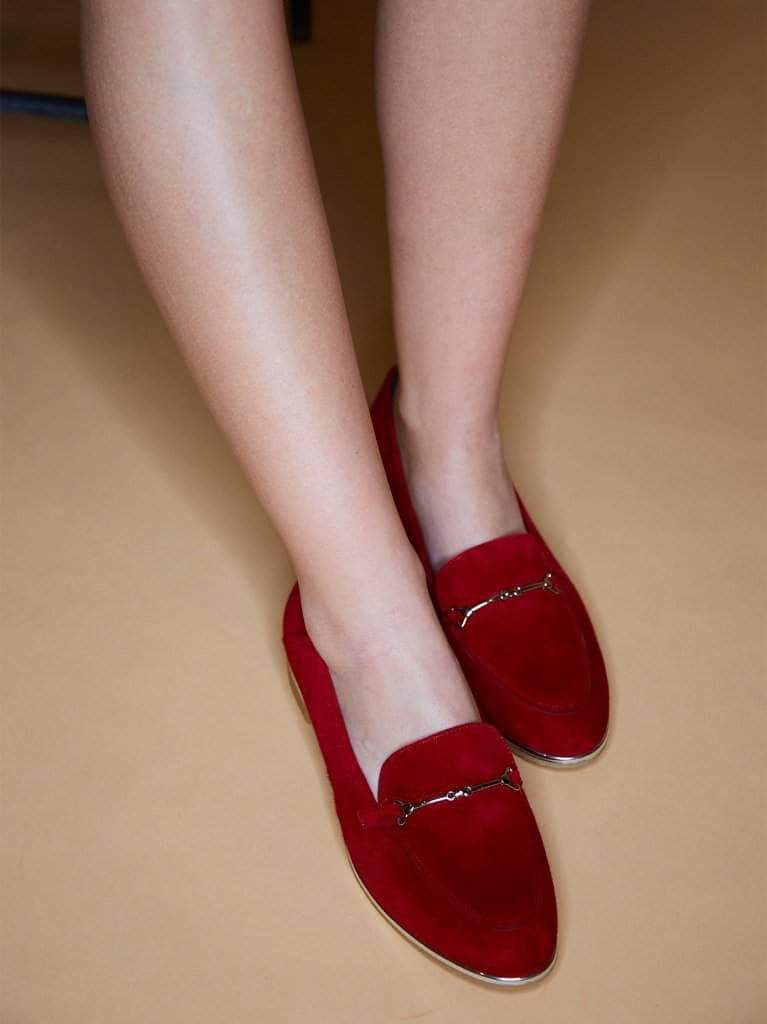 This red pump has a sleek finish featuring silver bar detailing.