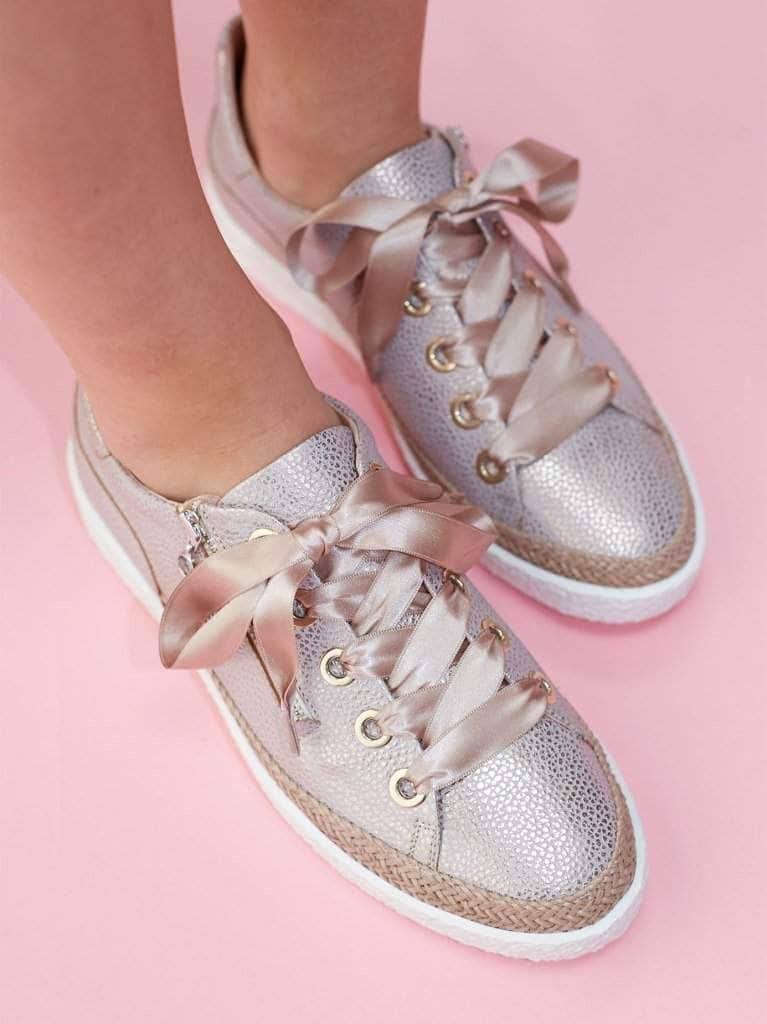 This modern trainer has statement silver eyelets with ribbon or standard laces. 