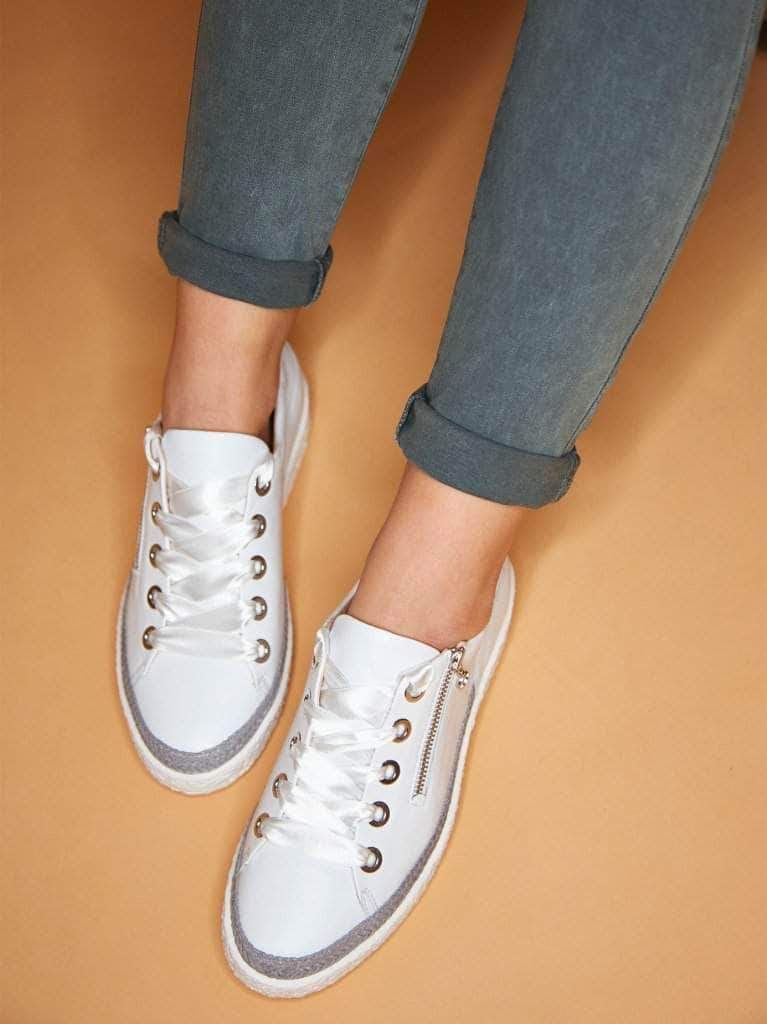 This modern trainer has statement silver eyelets with ribbon or standard laces. 
