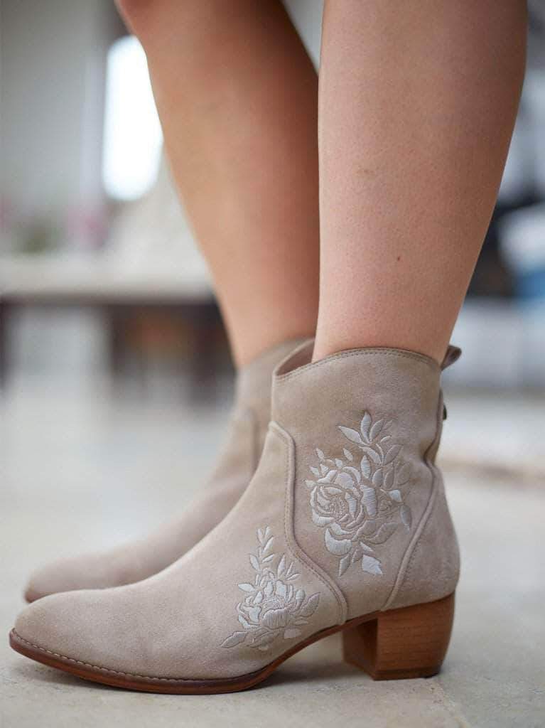 The Paxton is cut from luxe tan leather with a flattering curved topline.